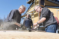 Working for a good cause: current and former employees of the Friedhelm Loh Group help complete the interiors of the wooden lodges at the youth retreat near Oberndorf.